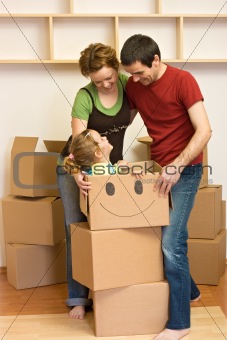 Happy family unpacking in their new home