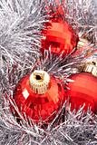 Red Christmas balls among silver glittering decoration