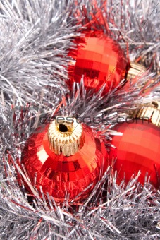 Red Christmas balls among silver glittering decoration