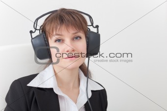 Portrait of young woman with big ear-phones on head