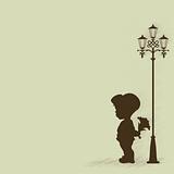 Boy with a bouquet of standing under a street lamp
