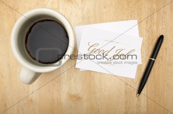 Good Job Note Card, Pen and Coffee Cup on Wood Background.