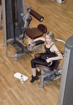Boy and a girl using excercise machines