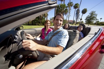 Family Driving In Convertible Car