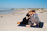 Young married couple kissing on the beach