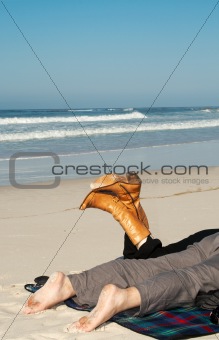 Couple lying on the sandy beach in winter