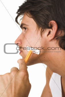 close up of young man shaving