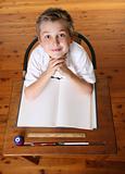 Child at desk with open book