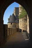 View at Carcassonne castle  through an old stone archway