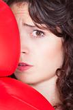 fearful young woman with red boxing gloves