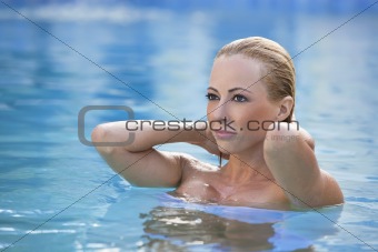 Beautiful Blond Woman In A Blue Swimming Pool