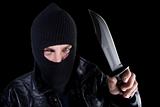 Man in mask with large knife on black