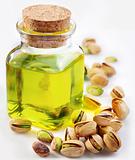Pistachio oil with nuts on a white background