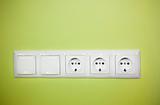 Electrical wall outlet / on green background
