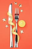 knife and fork with ribbon, stars and candle