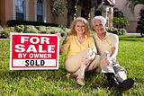 Senior Couple With For Sale Sold By Owner House SIgn
