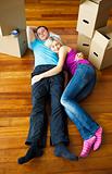 Couple sleeping on the floor. Moving house