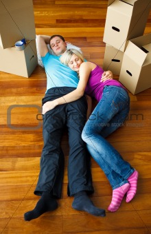 Couple sleeping on the floor. Moving house