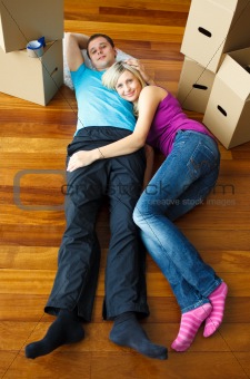 Couple lying on the floor. Moving house