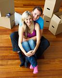 High angle of a couple sitting on floor. Moving house