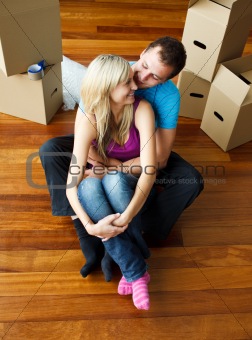 Happy young couple sitting on floor. Moving house