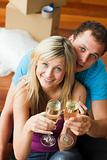 Lovers celebrating new house with champagne