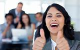 Happy businesswoman with thumbs up in office