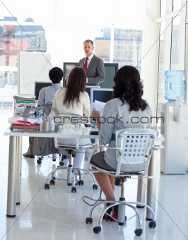 Businessman talking in front of his team