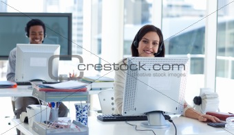 Businesswoman with a headset on working in a call center