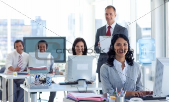 Male manager supervising his team in a call center