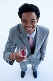 Smiling Afro-American businessman holding a glass of wine