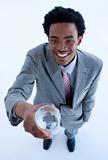 Smiling African businessman holding a glass of water