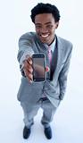 Afro-American businessman showing a mobile phone to the camera