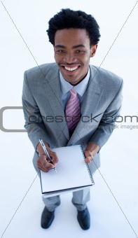 Businessman writing notes in a notebook