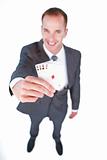 High angle of a smiling businessman holding aces
