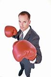 Serious businessman boxing against white background