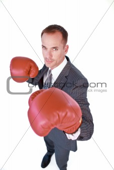 Serious businessman boxing against white background