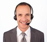 Smiling businessman with a headset on 