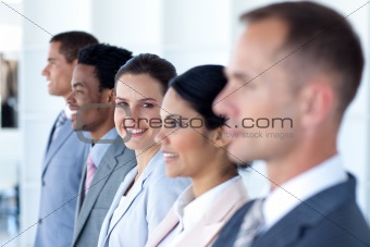 Attractive businesswoman with her team in a row