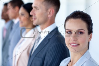 Confident businesswoman with her team in a line