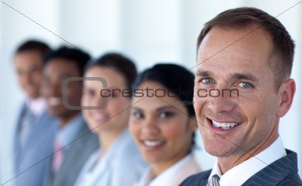 Attractive businessman in a row with his team