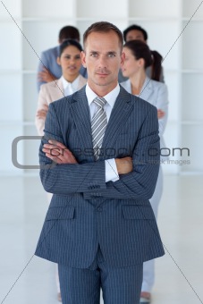 Young businessman with a team in the background