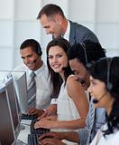 Businesswoman in a call center with her team and manager