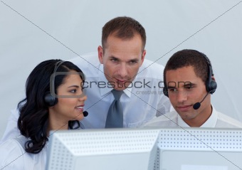 Manager helping business people in a call canter 