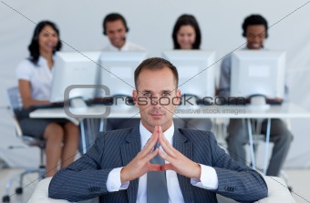 Manager sitting in call center in front of his team