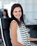 Smiling businesswoman sitting in her workplace