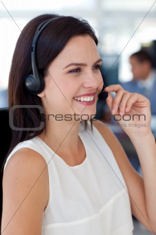 Businesswoman talking on a headset in a call centre