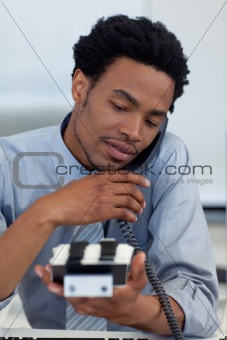 Young ethnic businessman on phone