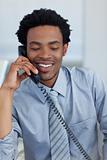 Afro-American businessman on phone in office