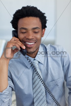 Afro-American businessman on phone in office